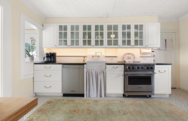 197A Perkins St, Castine, ME 04421 - kitchen featuring stainless steel appliances, light floors, white cabinetry, glass insert cabinets, and an ornate ceiling