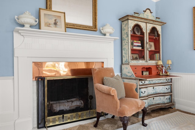197A Perkins St, Castine, ME 04421 - living area with a glass covered fireplace and wainscoting