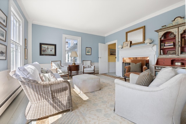 197A Perkins St, Castine, ME 04421 - living room with baseboard heating, crown molding, and a wainscoted wall