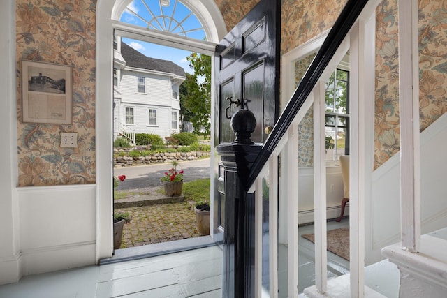 197A Perkins St, Castine, ME 04421 - doorway to outside featuring wallpapered walls, a wainscoted wall, stairs, and baseboard heating