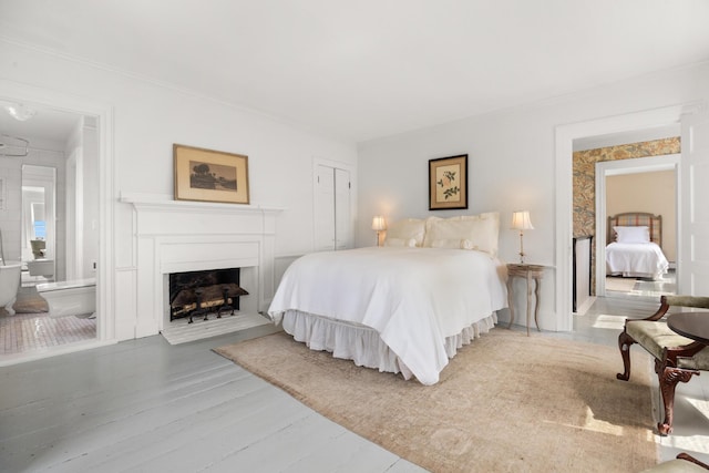 197A Perkins St, Castine, ME 04421 - bedroom featuring ornamental molding, wood finished floors, a fireplace, and a closet