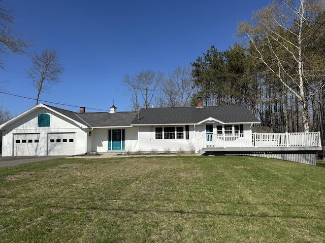 365 Snakeroot Rd, Pittsfield, ME 04967 - single story home featuring aphalt driveway, a chimney, a deck, a front lawn, and an attached garage