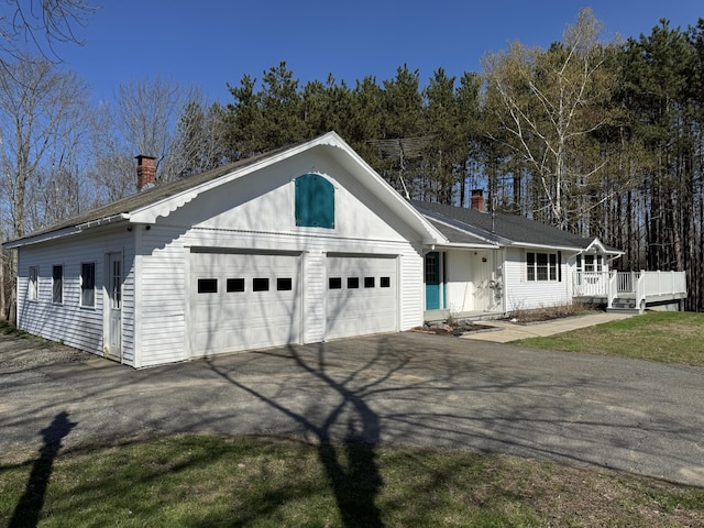 365 Snakeroot Rd, Pittsfield, ME 04967 - view of front facade with a deck, driveway, and a chimney
