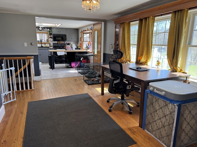 365 Snakeroot Rd, Pittsfield, ME 04967 - office space with a sink, an inviting chandelier, and light wood finished floors
