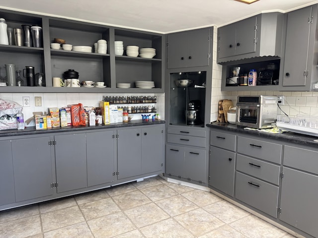 365 Snakeroot Rd, Pittsfield, ME 04967 - kitchen with dark countertops, gray cabinetry, decorative backsplash, and open shelves