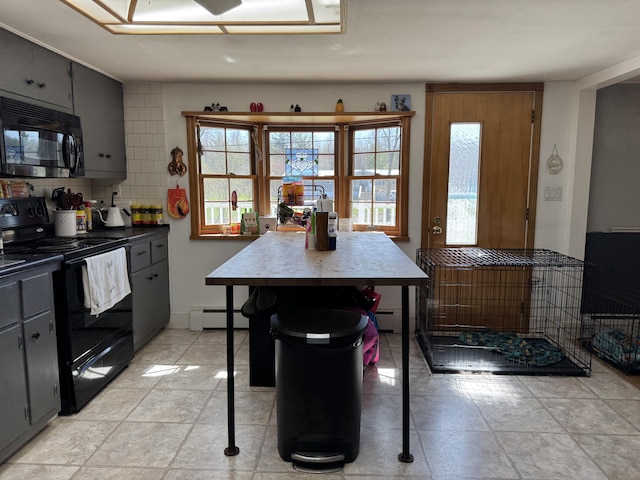 365 Snakeroot Rd, Pittsfield, ME 04967 - kitchen with decorative backsplash, dark countertops, baseboard heating, gray cabinets, and black appliances