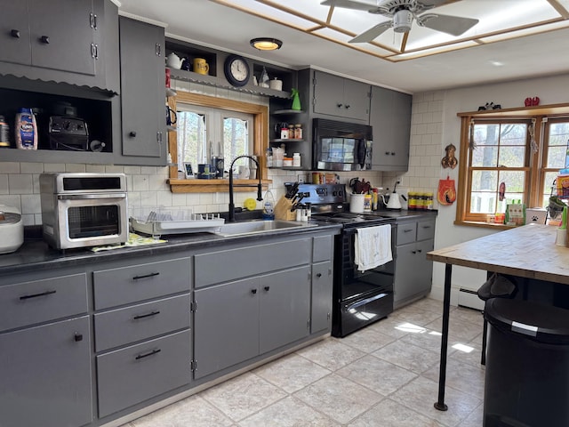 365 Snakeroot Rd, Pittsfield, ME 04967 - kitchen featuring dark countertops, open shelves, a sink, gray cabinets, and black appliances
