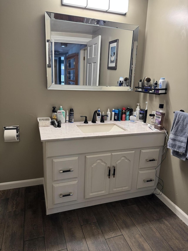 365 Snakeroot Rd, Pittsfield, ME 04967 - bathroom with baseboards, vanity, and wood finished floors