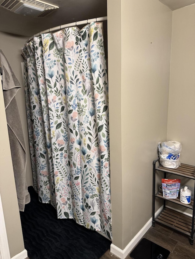 365 Snakeroot Rd, Pittsfield, ME 04967 - full bath with baseboards, a shower with curtain, wood finished floors, and visible vents