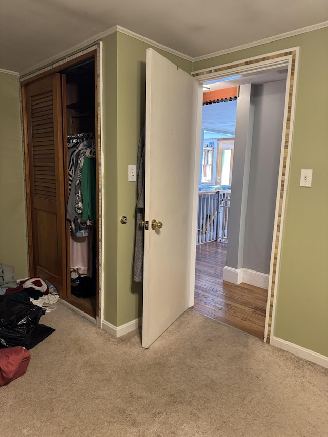 365 Snakeroot Rd, Pittsfield, ME 04967 - unfurnished bedroom featuring crown molding, carpet floors, baseboards, and a closet