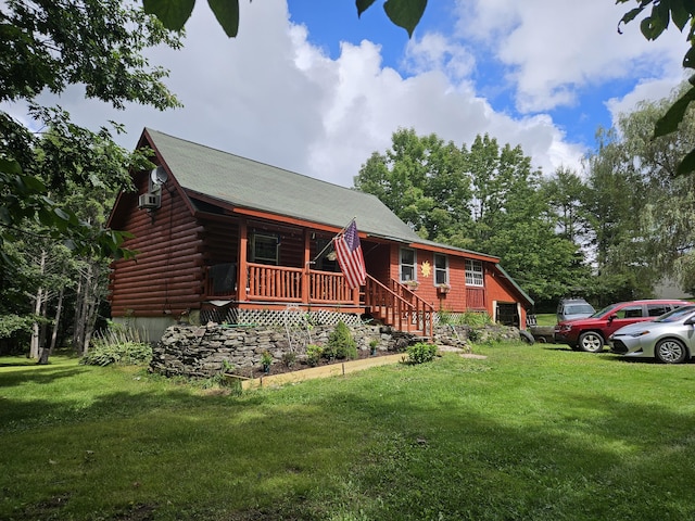 view of front of property with a front lawn, covered porch, and log exterior