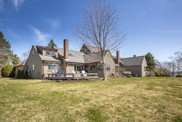 53 Jameson Point Rd Unit 24, Rockland, ME 04841 - rear view of house featuring a yard, roof with shingles, a chimney, and a wooden deck