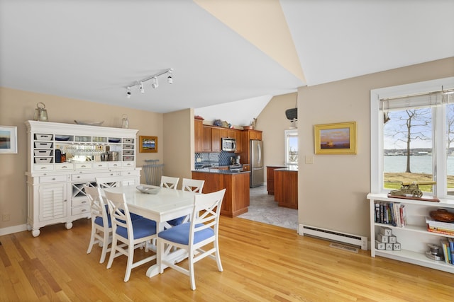 53 Jameson Point Rd Unit 24, Rockland, ME 04841 - dining room featuring rail lighting, a wealth of natural light, a baseboard radiator, and light wood finished floors