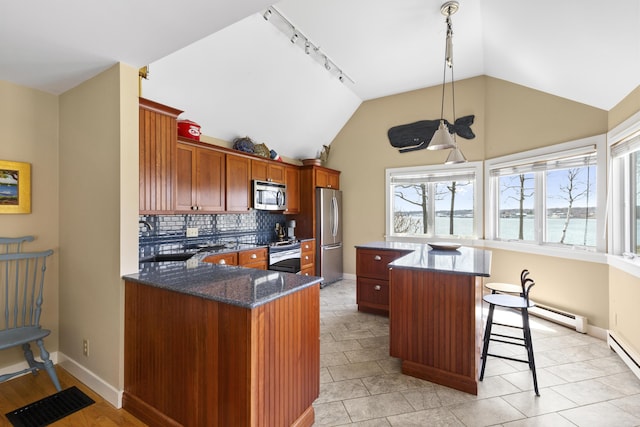 53 Jameson Point Rd Unit 24, Rockland, ME 04841 - kitchen featuring rail lighting, lofted ceiling, tasteful backsplash, and appliances with stainless steel finishes