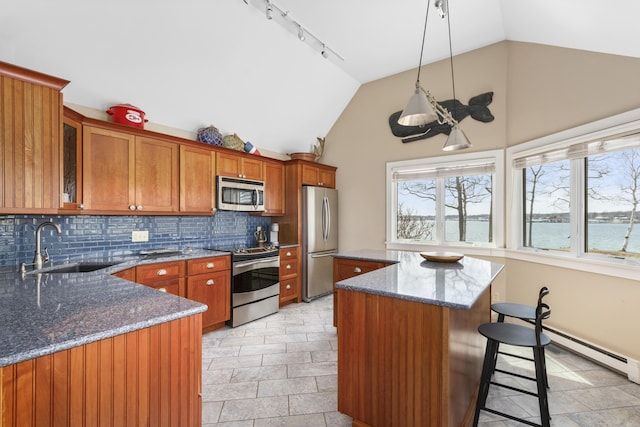 53 Jameson Point Rd Unit 24, Rockland, ME 04841 - kitchen featuring a sink, stainless steel appliances, brown cabinets, a healthy amount of sunlight, and backsplash