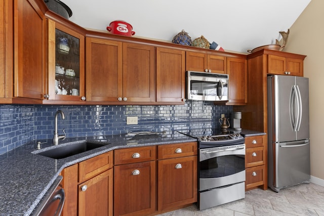 53 Jameson Point Rd Unit 24, Rockland, ME 04841 - kitchen featuring a sink, brown cabinets, dark stone counters, and appliances with stainless steel finishes