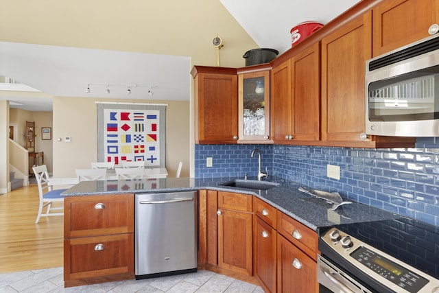 53 Jameson Point Rd Unit 24, Rockland, ME 04841 - kitchen featuring a sink, a peninsula, stainless steel appliances, and brown cabinets