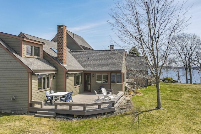 53 Jameson Point Rd Unit 24, Rockland, ME 04841 - back of house with a yard, a wooden deck, a shingled roof, and a chimney