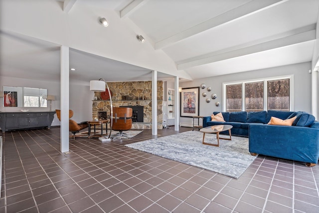 living room featuring vaulted ceiling with beams and dark tile patterned flooring