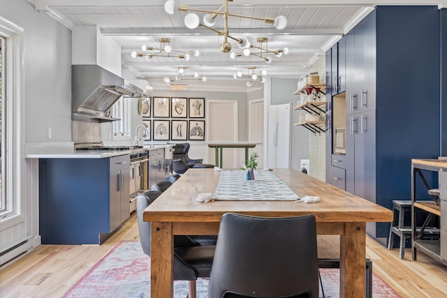 dining space featuring beamed ceiling, baseboard heating, light wood-type flooring, and a notable chandelier