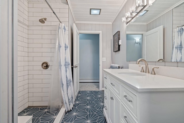 bathroom with vanity, ornamental molding, baseboard heating, and a stall shower