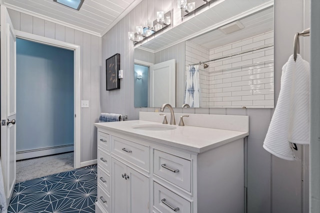 full bath featuring curtained shower, baseboard heating, and vanity
