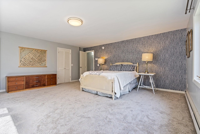 bedroom featuring carpet flooring, baseboards, baseboard heating, and a closet