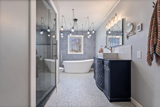 bathroom with walk in shower, vanity, a chandelier, baseboards, and a soaking tub