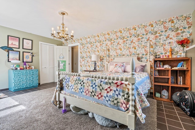 tiled bedroom with an inviting chandelier, a closet, and wallpapered walls