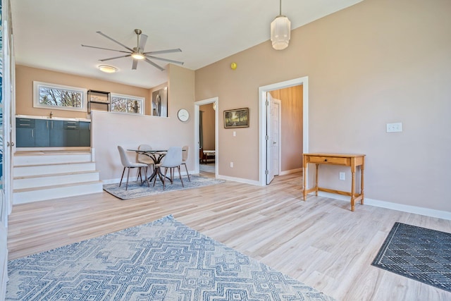interior space featuring baseboards, ceiling fan, and wood finished floors