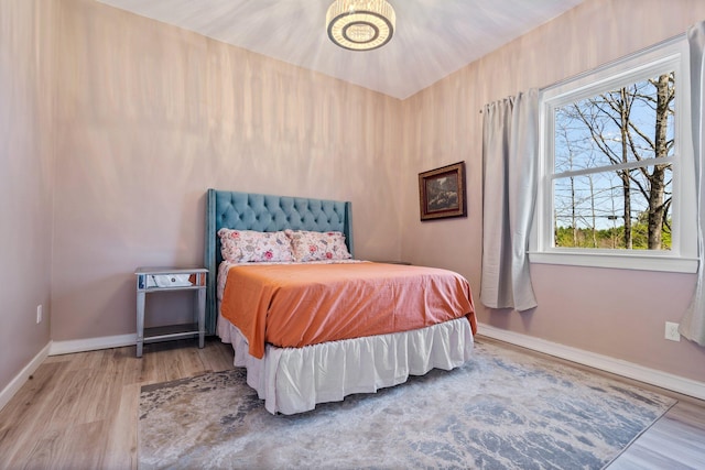 bedroom featuring baseboards and wood finished floors