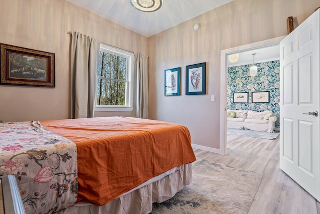 bedroom with light wood-style floors and baseboards