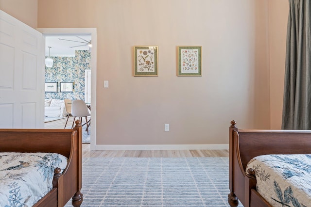 bedroom featuring baseboards and wood finished floors