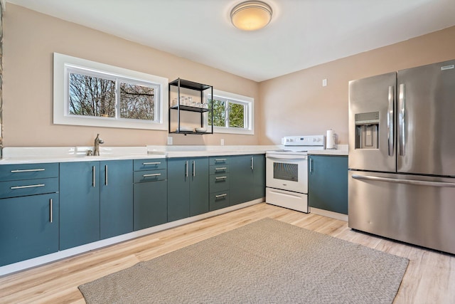 kitchen with light countertops, light wood-type flooring, white electric stove, and stainless steel refrigerator with ice dispenser