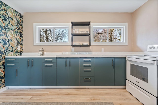kitchen with light countertops, light wood-style floors, and white electric range