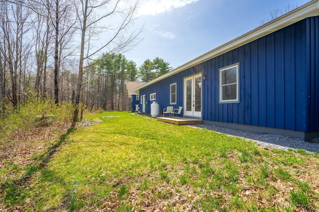 view of yard with french doors and a deck