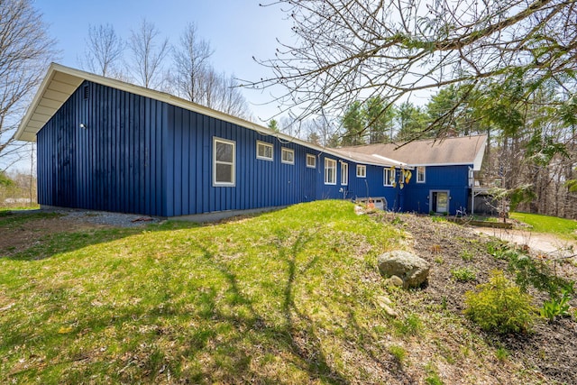 view of front of home with board and batten siding and a front yard