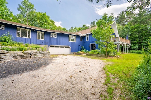 314 Meadow Rd, Topsham, ME 04086 - view of front of home with driveway, board and batten siding, an attached garage, and a deck