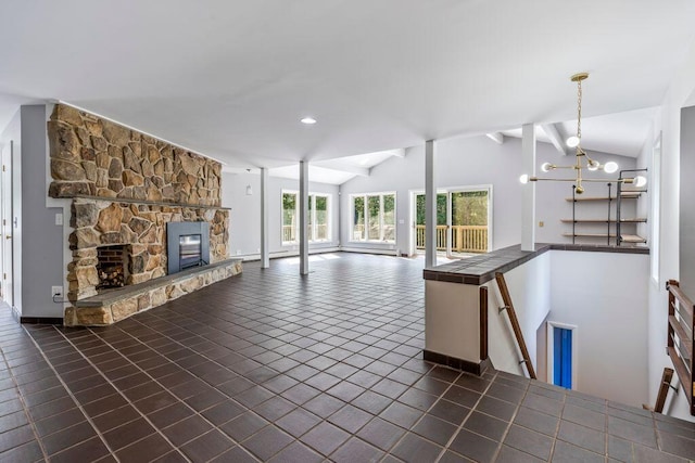 314 Meadow Rd, Topsham, ME 04086 - unfurnished living room featuring lofted ceiling, a stone fireplace, a chandelier, and dark tile patterned floors