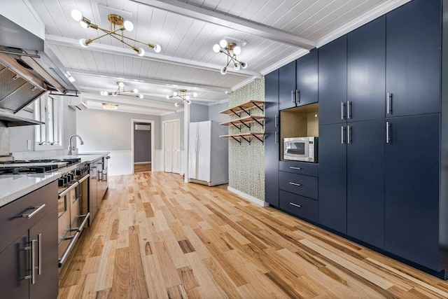 314 Meadow Rd, Topsham, ME 04086 - kitchen featuring a chandelier, freestanding refrigerator, blue cabinets, range with two ovens, and exhaust hood