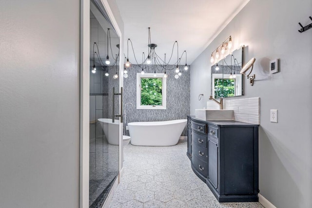 314 Meadow Rd, Topsham, ME 04086 - bathroom featuring vanity, a freestanding bath, and a chandelier