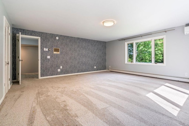 314 Meadow Rd, Topsham, ME 04086 - carpeted empty room featuring baseboard heating, wallpapered walls, an accent wall, and a wall mounted AC