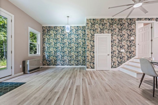 314 Meadow Rd, Topsham, ME 04086 - unfurnished dining area with wallpapered walls, heating unit, healthy amount of natural light, ceiling fan, and wood finished floors