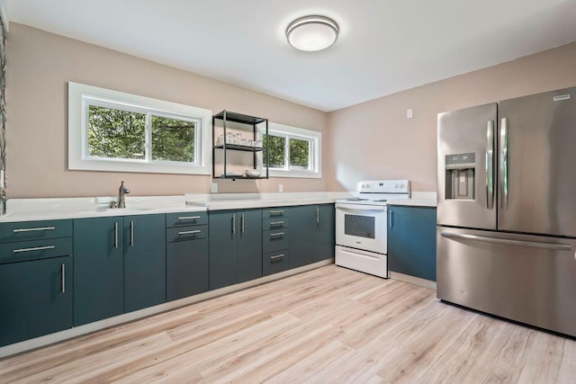 314 Meadow Rd, Topsham, ME 04086 - kitchen with stainless steel refrigerator with ice dispenser, white range with electric cooktop, light wood-style floors, and light countertops