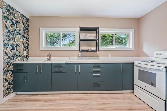 314 Meadow Rd, Topsham, ME 04086 - kitchen with white electric range, plenty of natural light, light countertops, and light wood finished floors