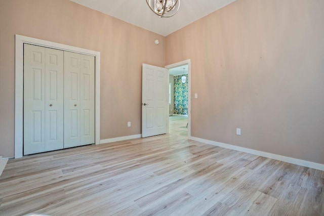 314 Meadow Rd, Topsham, ME 04086 - unfurnished bedroom featuring a chandelier, light wood-type flooring, and a closet