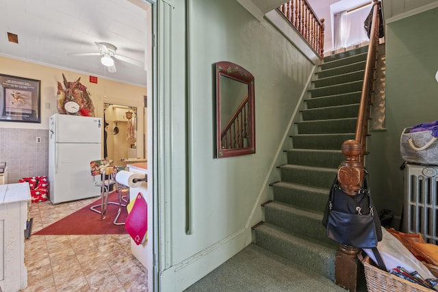27 Townsend Ave, Boothbay Harbor, ME 04538 - staircase with crown molding, tile walls, and ceiling fan