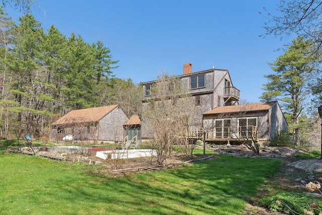 back of property with a lawn, a gazebo, and a chimney