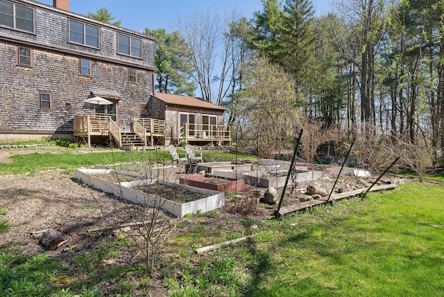 view of yard featuring a garden and a wooden deck