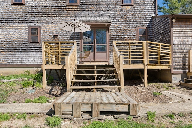 view of exterior entry featuring a wooden deck